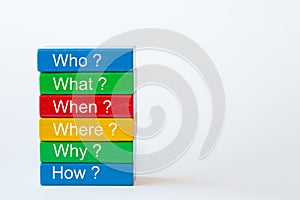 The words: Who, What, When, Where, Why and How are written on colorful blocks photo