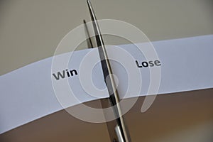 Words `WIN or LOSE` on paper background