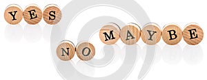 Words Yes No Maybe from circular wooden tiles with letters children toy.