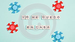 Words yo me quedo en casa that mean i stay at home made of wooden blocks, concept of self quarantine at home as preventative