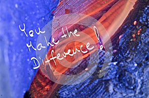 Words You make the difference! handwritten on red burn wooden background