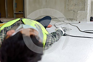 Work accident electric short circuit to a worker in the workplace and Unconscious lying on the floor after hand connecting power