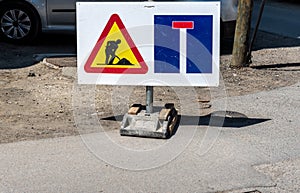 Work ahead caution or warning traffic road sign on the closed street to warn drivers of reconstruction or reparation of the asphal
