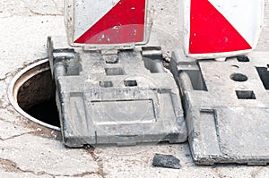 Work ahead street reconstruction site with sign and fence as road barricade