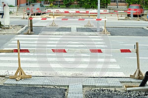 Work ahead street reconstruction site with sign and fence as road barricade