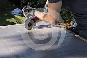 Work with angle grinder machine - sparkling lights of cutting metal