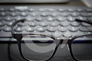Work area with keyboard and eye glasses