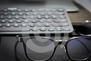 Work area with keyboard and eye glasses