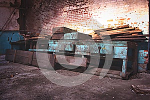 Work bench in an abandoned factory against brick wall