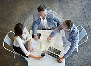 They work better together. High angle shot of three businesspeople working in the office.