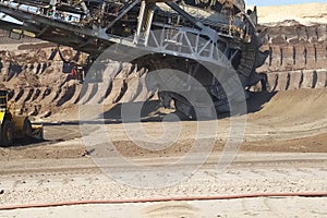 work of a bucket wheel excavator in a quarry. Ore mining in a quarry