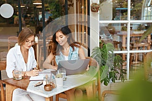 Work At Cafe. Women With Laptop Working Remotely On Summer Vacation At Tropical Country. Digital Nomad Lifestyle photo