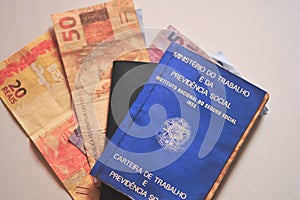 Work card with Brazilian money on white background. Brazilian financial fund created by companies photo