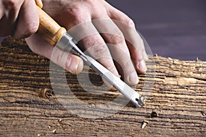 Work of carpenter. Handyman with chisel. Hand holding chisel. Woodworking and craft carpenter. Carpenter tools. Woodworker