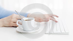 Work on a computer with a cup of coffee.