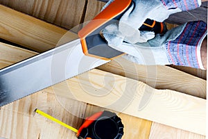 Work on the construction or repair house. Renovation. Use saw work gloves Concept for DIY, workplace safety, worker protection