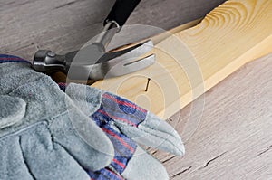 Work on the construction or repair of the house.Use working gloves and a hammer. Concept for DIY, workplace safety, protection