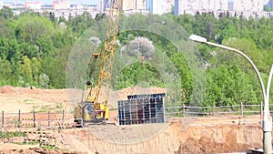 Work on the construction site. The construction crane moves the building structures.