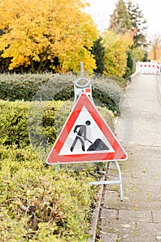 Construction site sign cordoning off on a road photo