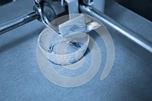 Work 3d printer close up. Printing 3D printer Object plastic On blue background.