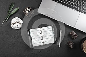 Work desk for a businessman, laptop and work planbook, breakfast sweets and milk coffee photo