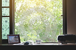 A work desk with a natural atmosphere outside the window with the morning sun