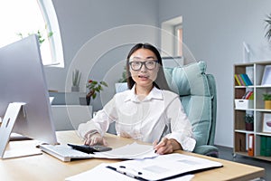 Work with documents. Portrait of a young business woman Asian accountant works with documents