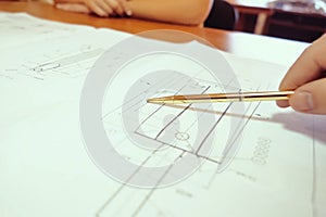 Work on a drawing of diagram by an engineer. Engineer's hand over the drawing