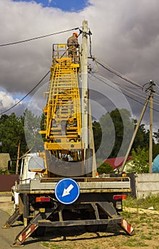 Work on electric post power pole Electrician lineman repairman worker at climbing