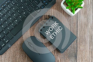 Work ethic text on note pad on top of desk flat lay photo