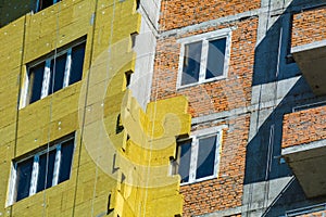 Work on the external walls of glass wool insulation and plaster