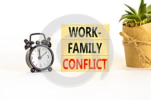 Work-family conflict symbol. Concept words Work-family conflict on wooden block on a beautiful white table white background. Black