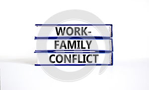 Work-family conflict symbol. Concept words Work-family conflict on books on a beautiful white table white background. Business