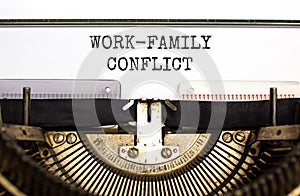 Work-family conflict symbol. Concept words Work-family conflict on white paper typed on old retro typewriter on beautiful white