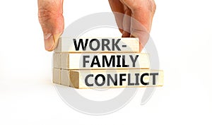 Work-family conflict symbol. Concept words Work-family conflict on wooden block on a beautiful white table white background.