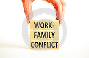 Work-family conflict symbol. Concept words Work-family conflict on wooden block on a beautiful white table white background.
