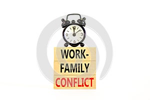 Work-family conflict symbol. Concept words Work-family conflict on wooden block on a beautiful white table white background. Black