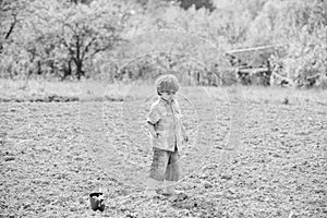 Work at farm. Mother nature concept. Planting seedlings. Child having fun with little shovel and plant in pot. Planting