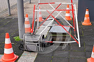Work Fibre optic cable in city street digital fiber Internet connection cables crossing open manhole with few cables connection