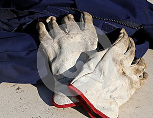 Work gloves over a worker overalls