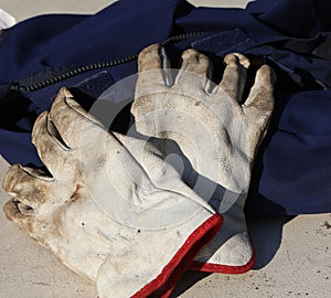 Work gloves over a worker overalls during the strike