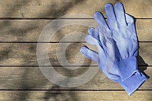 Work gloves on rustic background, gardening season concept, flat lay, copy space