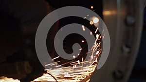 Work grinder cuts metal at the factory. Heavy industry worker cuts a huge pipe