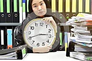 Work hard, Office worker holding a clock, Working overtime and lot of work