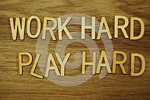 Work Hard Play Hard alphabet letters on wooden background business concept