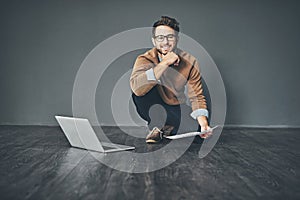 Work hard for what you want to achieve. Studio portrait of a young businessman working on a laptop against a grey