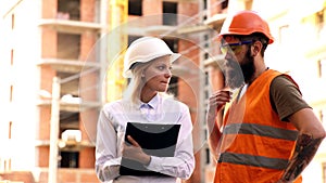 Work at the heavy industry manufacturing facility. Construction workers collaborating in the installation.