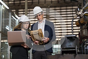 Work in a Heavy Industry Manufacturing Factory. Industrial man and woman engineer with laptop in control room of factory