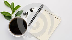 Work from home  with coffee cup, pen and notebook memo  on white background,top view