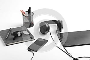 Work from home concept. smartphone, diary and earphone on white background